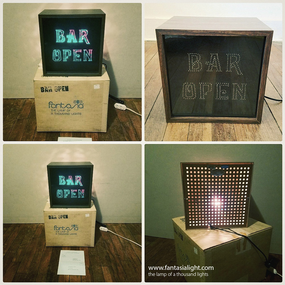 A similar concept to the highly popular Fantasia Glitter Graphics series which featured a glitter lamp concealed behind beautiful graphic artwork, the Fiber Graphics series removed the glitter lamp and replaced this with interesting fiber optics to create shimmering kinetic artwork. The first of Fantasia's Fiber Graphics seen by www.fantasialight.com was model 6017 Bar Open. Another design seen below is the Happy Hour, in beautiful condition, even with its warranty card! These designs often feature a high impact colourwheel designed to catch the attention of people. Other companies during this period, produced similar products such as the popular Fiber Flickers series produced by Way Electropics, that features designs such as an Owl and a Skier.