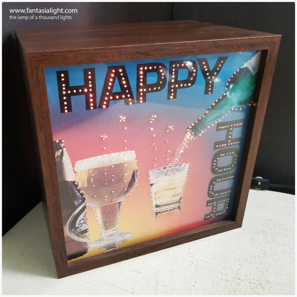 A similar concept to the highly popular Fantasia Glitter Graphics series which featured a glitter lamp concealed behind beautiful graphic artwork, the Fiber Graphics series removed the glitter lamp and replaced this with interesting fiber optics to create shimmering kinetic artwork. The first of Fantasia's Fiber Graphics seen by www.fantasialight.com was model 6017 Bar Open. Another design seen below is the Happy Hour, in beautiful condition, even with its warranty card! These designs often feature a high impact colourwheel designed to catch the attention of people. Other companies during this period, produced similar products such as the popular Fiber Flickers series produced by Way Electropics, that features designs such as an Owl and a Skier.